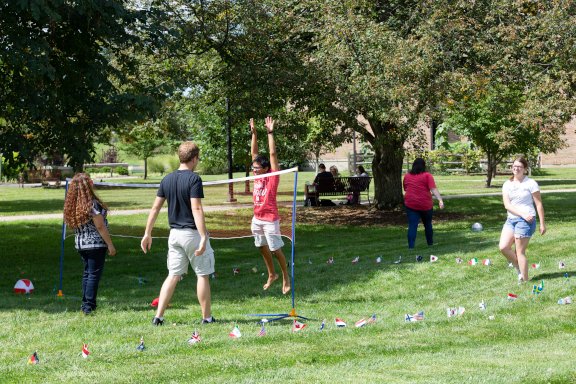 Students playing volleyball on the campus quad