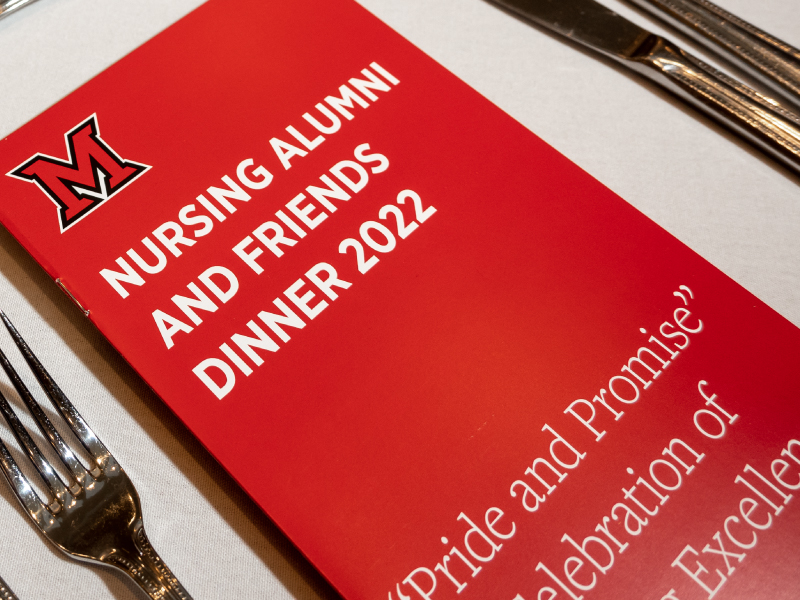 NSG Alumni dinner program on table. 