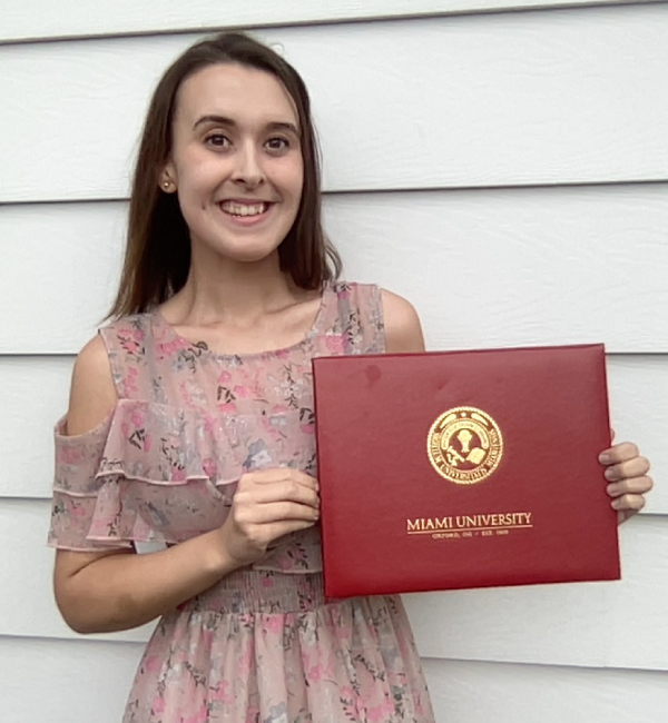 Kira Pierson holding her diploma