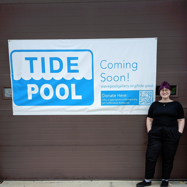 Jesseca Crosen standing in front of the Tide Pool banner