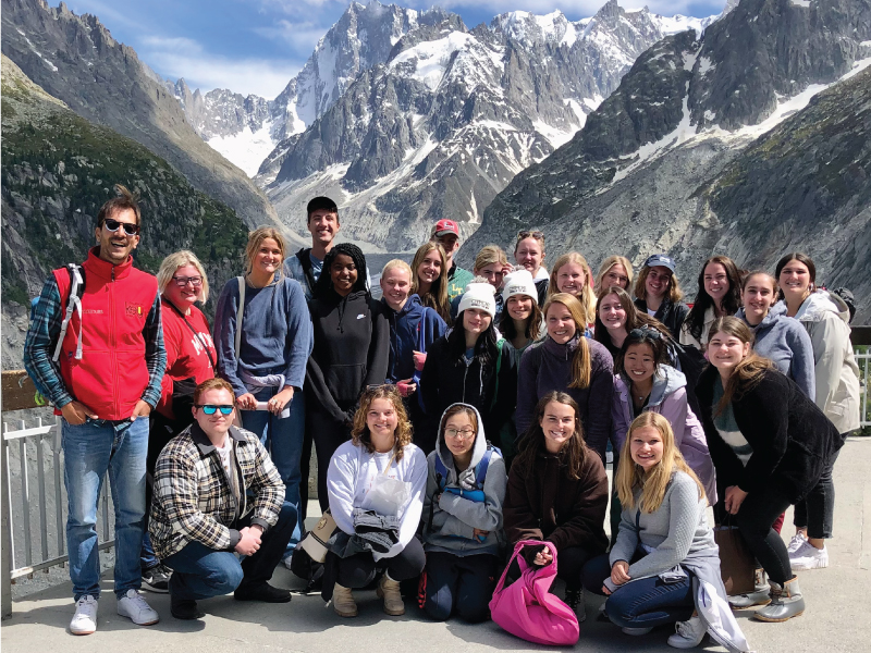 Caregiving in a Crisis students standing in front of Mer de Glace, the largest glacier in France, on their way up to Mont Blanc in the Alps