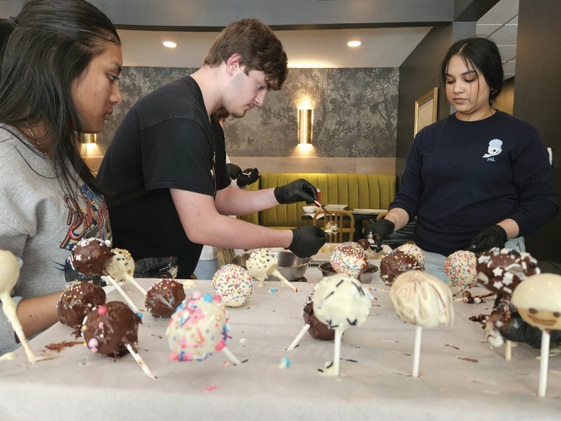 Upward Bound students decorating cake pops.