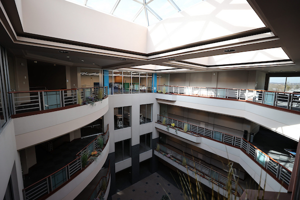 Interior atrium of the Advanced Manufacturing Workforce and Innovation Hub with 3 floors and a skylight.