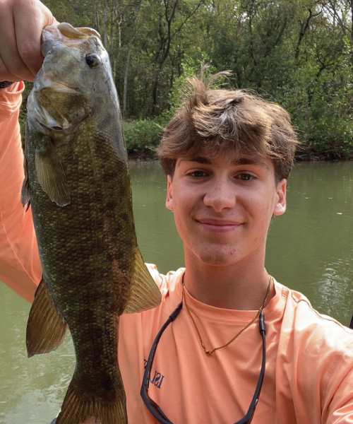 Corey Kiefer holding a bass fish