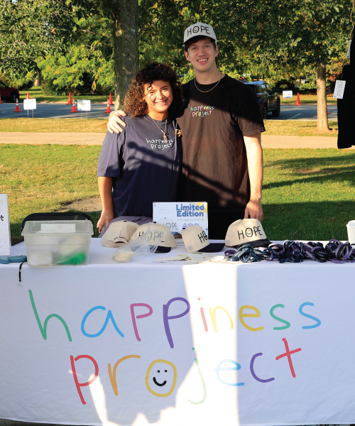 Mike Jones and his colleague behind the Happiness Project booth at an event.