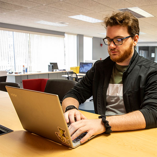 An adult learner working on his computer