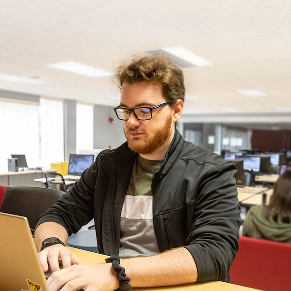 A person working in a computer and technology lab