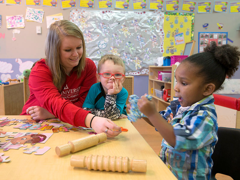 A student preschool teacher and two children