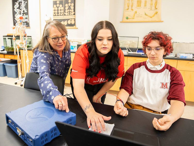 Miami students doing lab research with professor