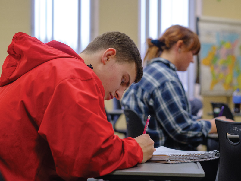 Student taking notes during class.