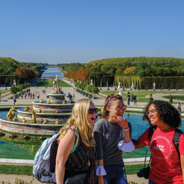 3 students standing in front of a fountain in Paris