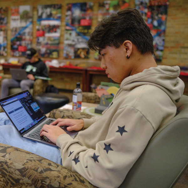 Student doing homework on his laptop