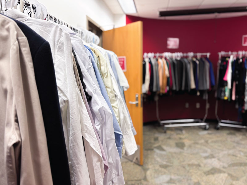 Clothes hanging on racks in the professional clothing closet at the Hamilton campus