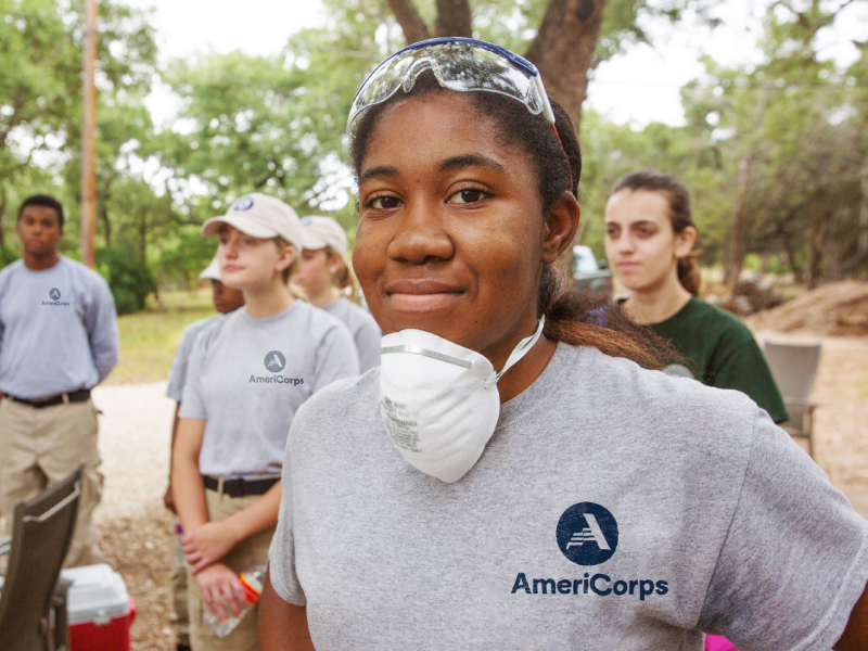 An Americorp change agent wearing a mask and safety glasses.