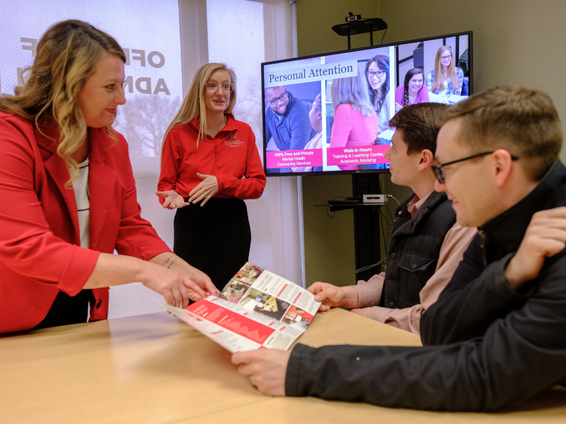 2 Admission counselors meeting with future students during a campus visit. 