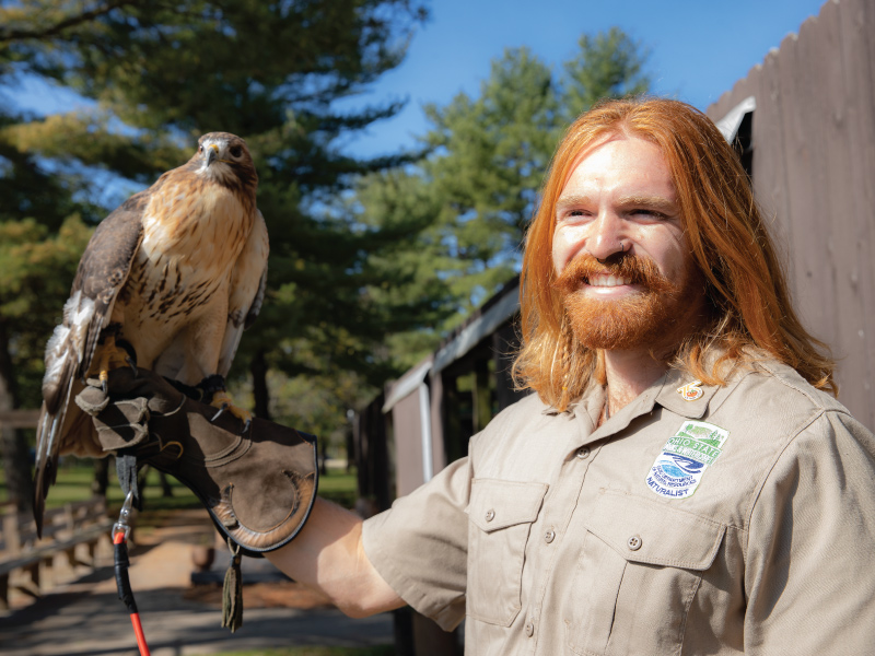 Miami student Skylar at his internship at Hueston Woods holding a hawk.