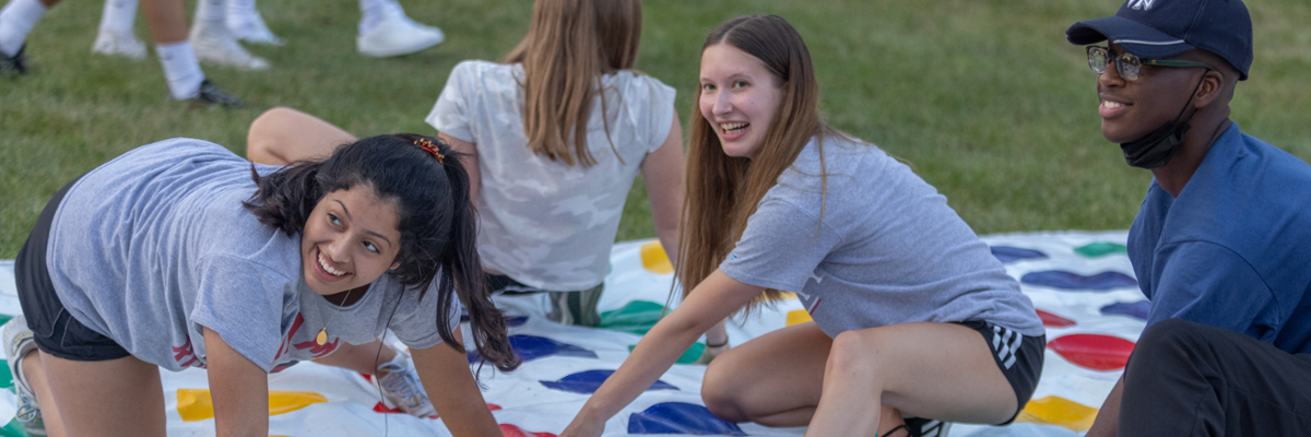 A few students playing twister at the first night block party