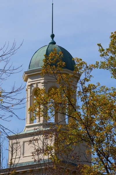 Campus tour against blue sky with changing leaves in front