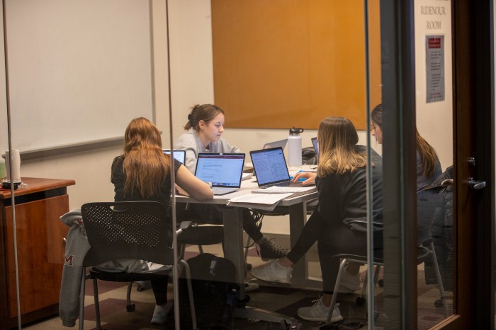 A small group of students on laptops in an Armstrong Study Room