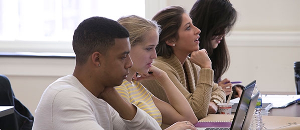 Four students working in a computer training class.