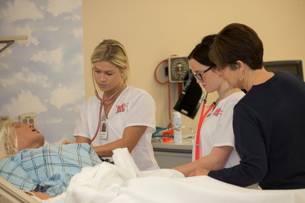 Nursing students working in the simulation lab