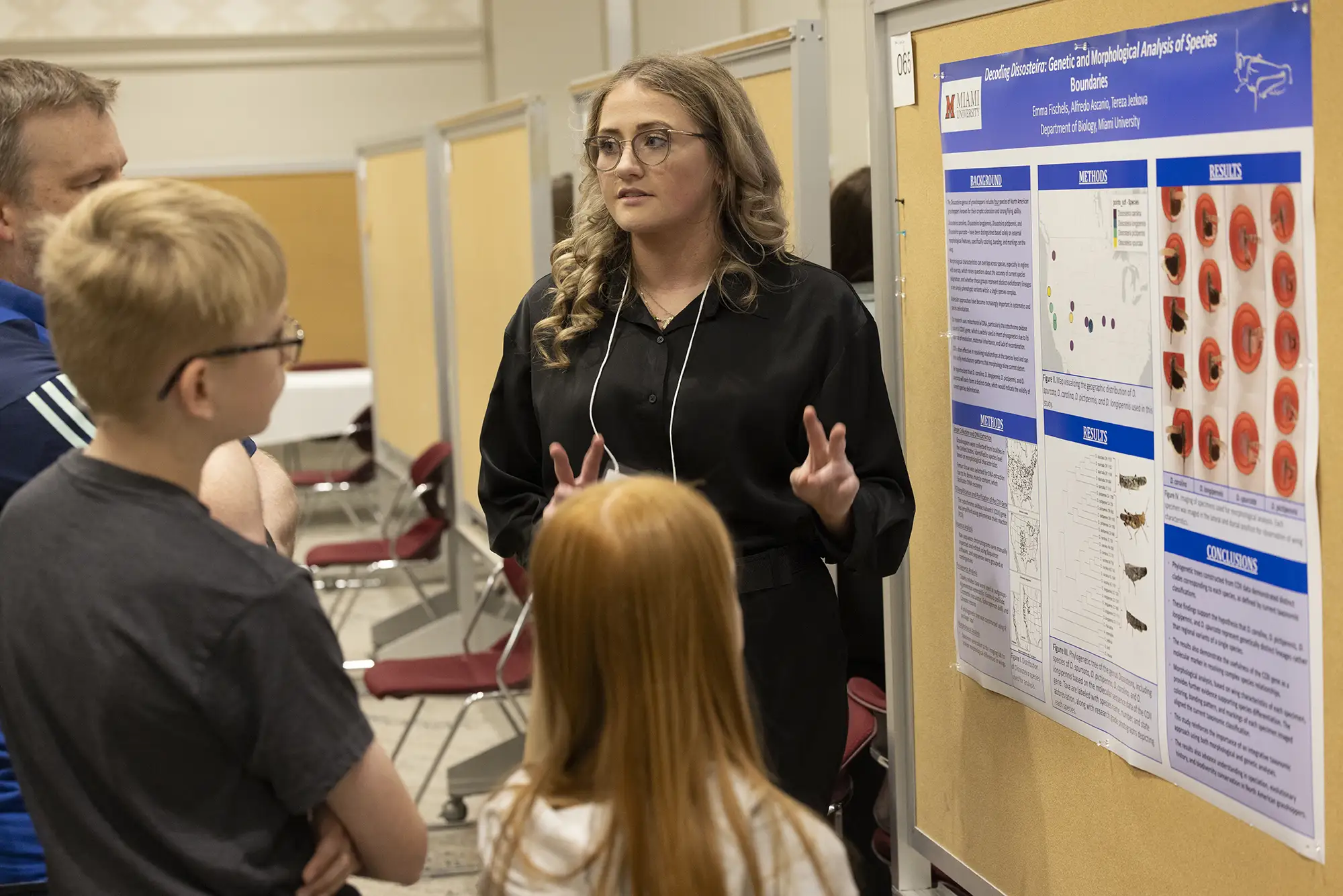 Miami student presenting research to a family
