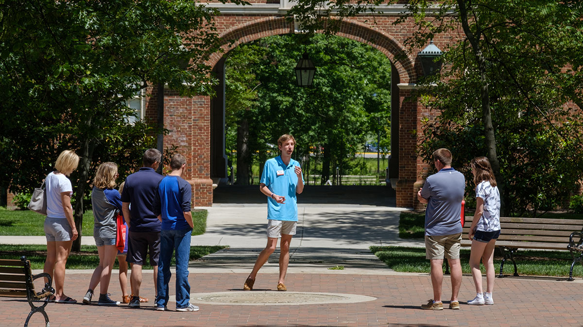 Tour guide in front of Upham Hall