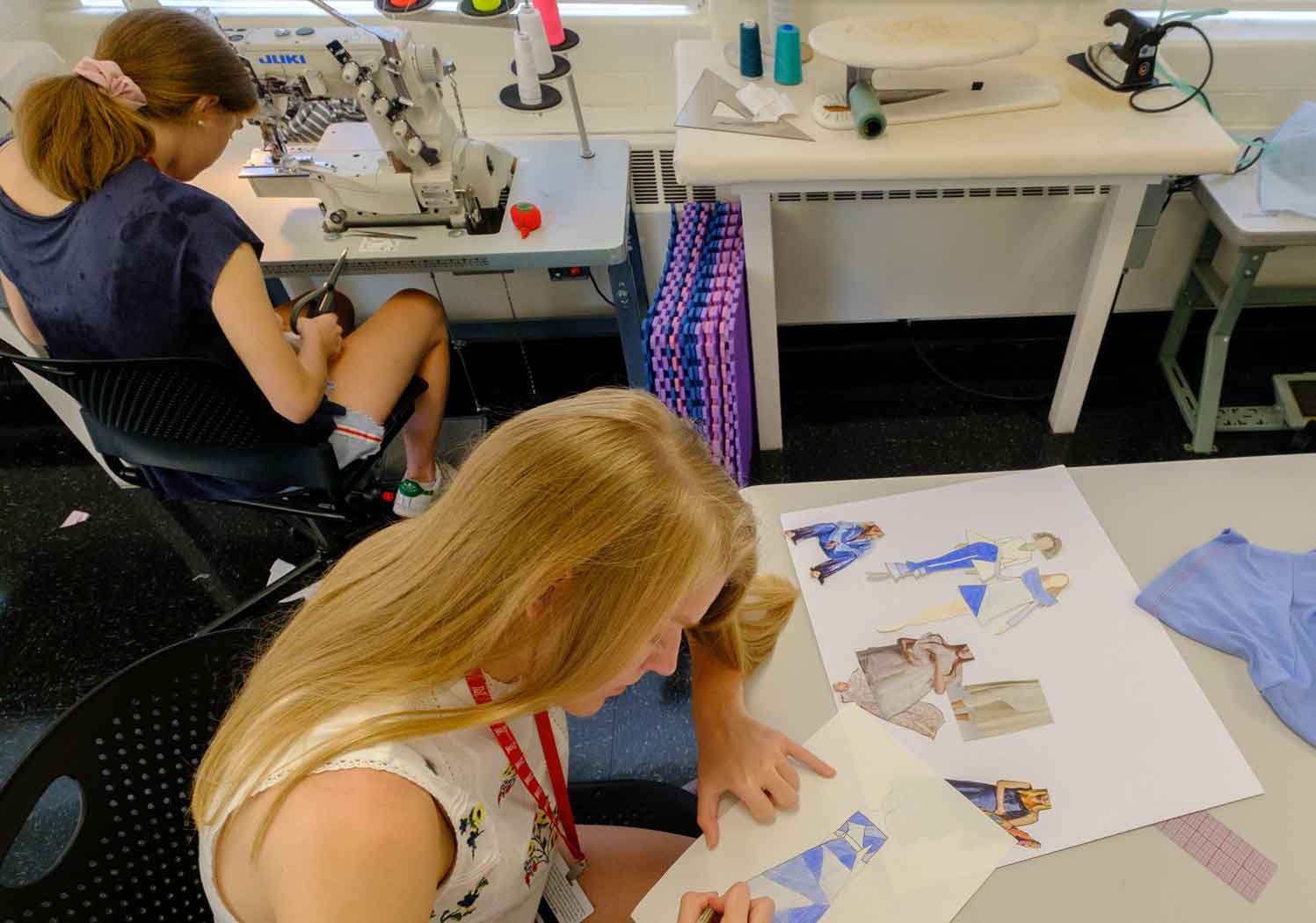 Two female students work on design project