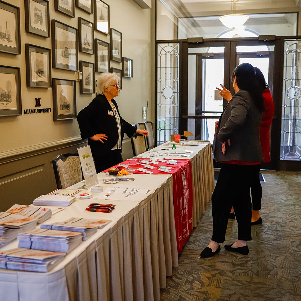 miami employee helping people attending conference