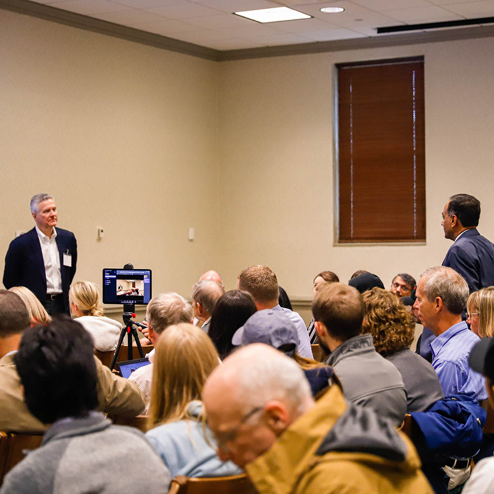 person presenting to group of people