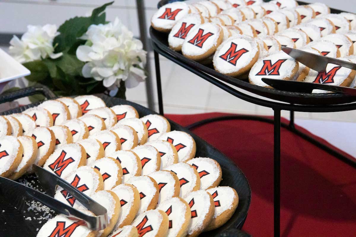 two platters of cookies decorated with the Miami University Beveled M