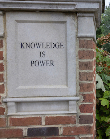 Sign etched in stone outside of Farmer School of Business that says Knowledge is Power