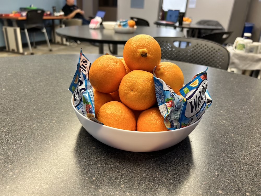 A group of oranges sitting in a bowl on a table in Benton Hall