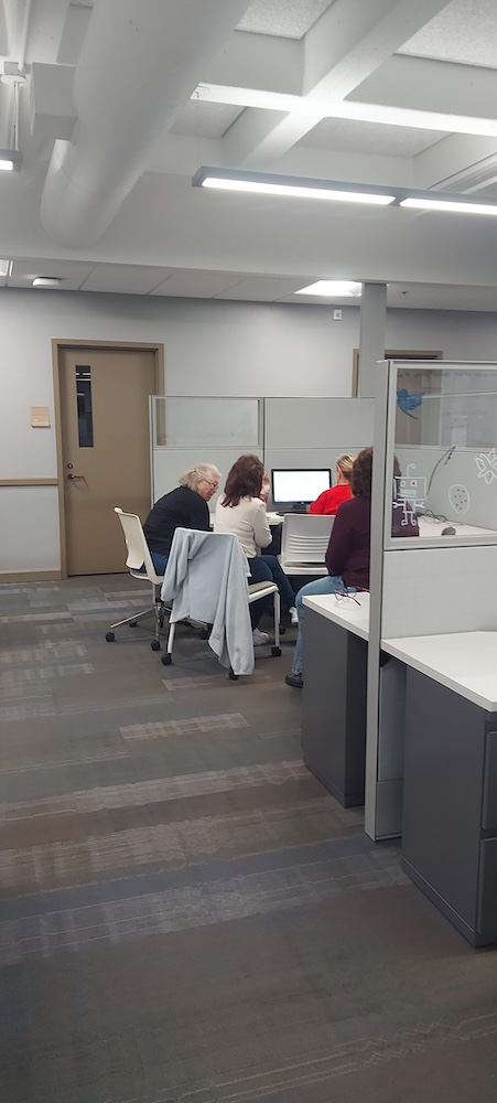 A small group of testers sitting around a table in a cubicle in Hoyt hall