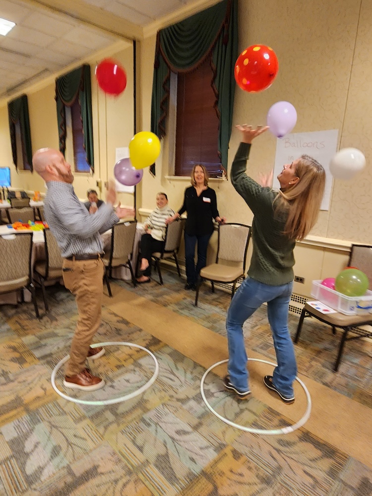Several Workday celebration attendees play a game with balloons