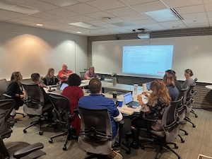 A group of Workday testers sitting around a table in a Hoyt Hall conference room