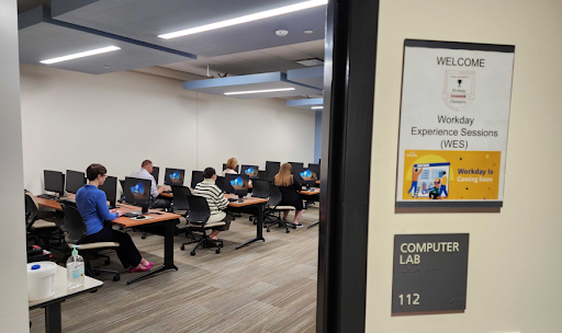 Workday experience session attendees working in the staff development computer lab