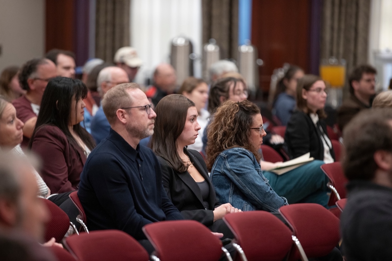 A group of people sitting in an auditorium.